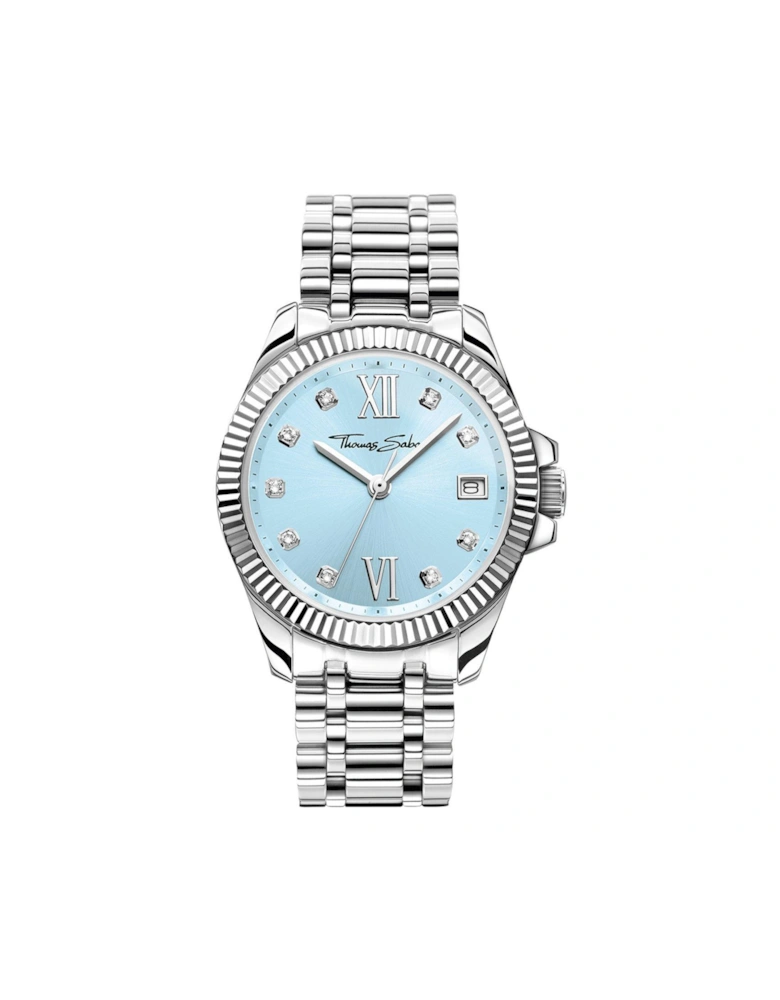 Women's Watch: Elegant light blue dial, white zirconia indexes, Roman numerals, fluted bezel, TS logo crown. Adjustable