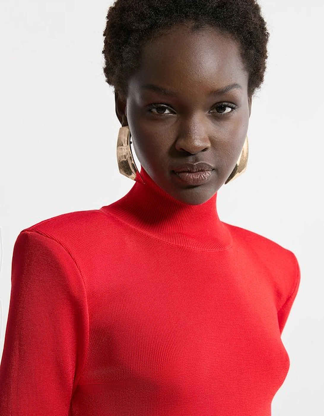 Slinky Drape Knit Power Shoulder Funnel Neck Top