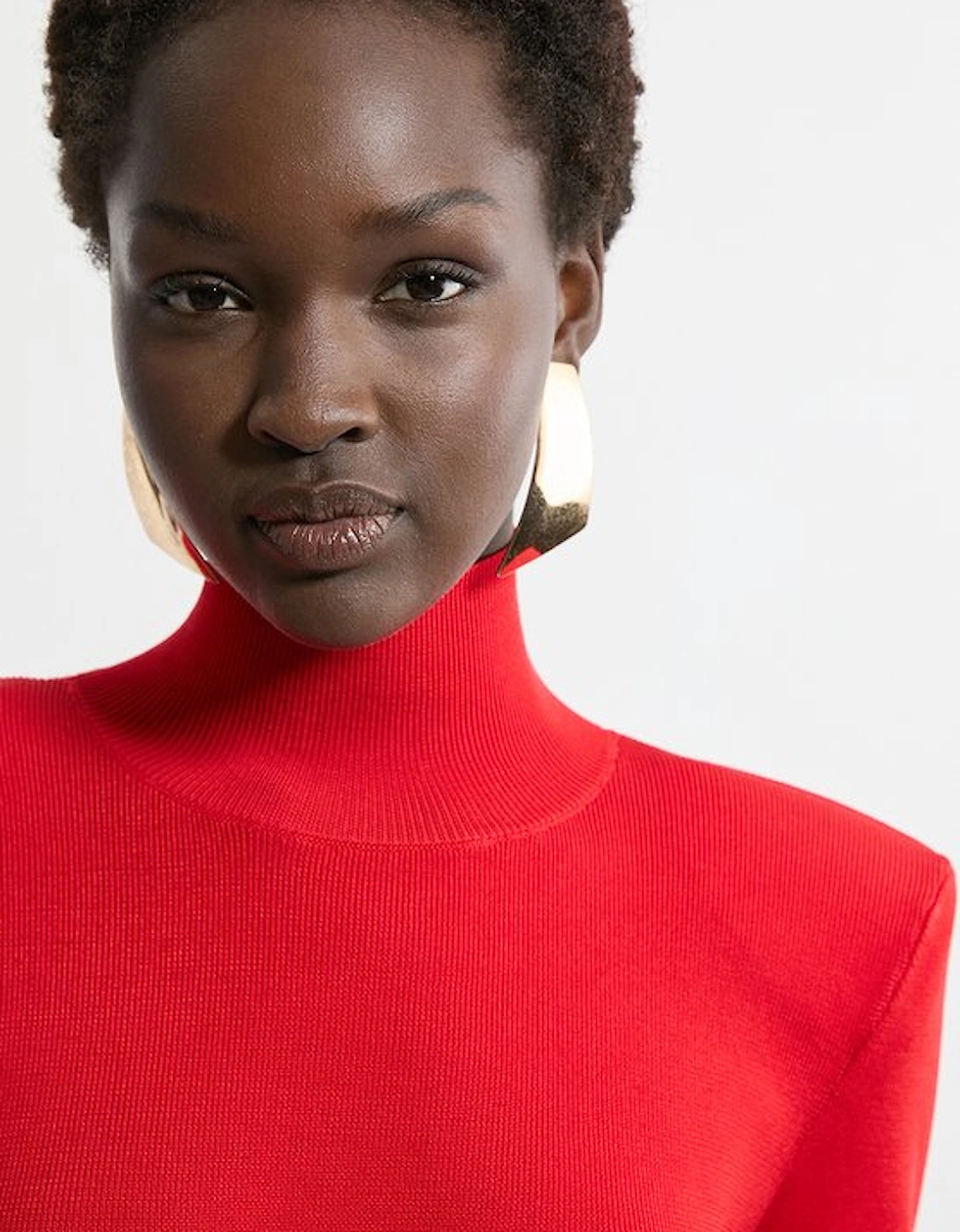 Slinky Drape Knit Power Shoulder Funnel Neck Top