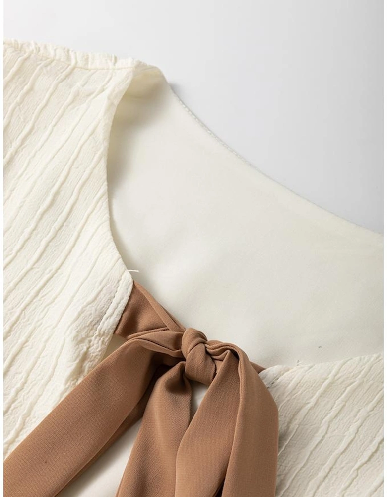 White Textured Bow Ties Front Bubble Hem Puff Short Sleeve Blouse