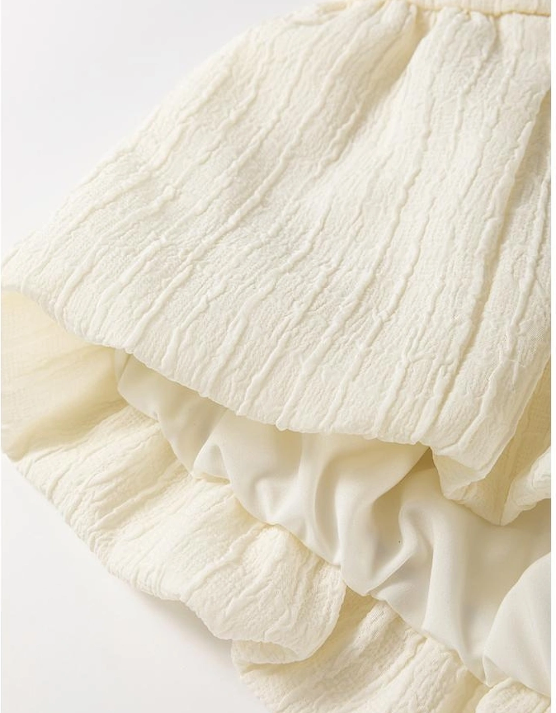 White Textured Bow Ties Front Bubble Hem Puff Short Sleeve Blouse