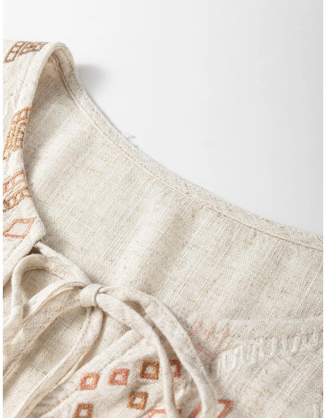 Jet Stream Geometric Embroidered Short Sleeve Tassel Tied V Neck Blouse