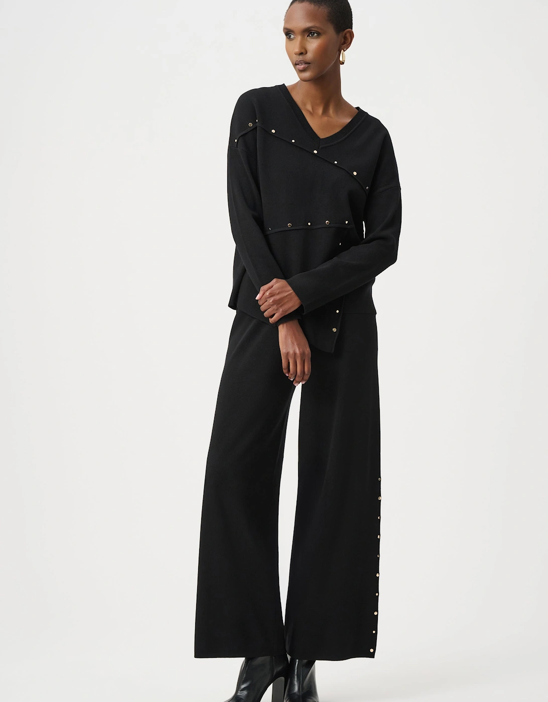 Asymmetric sweater with metal stud detail