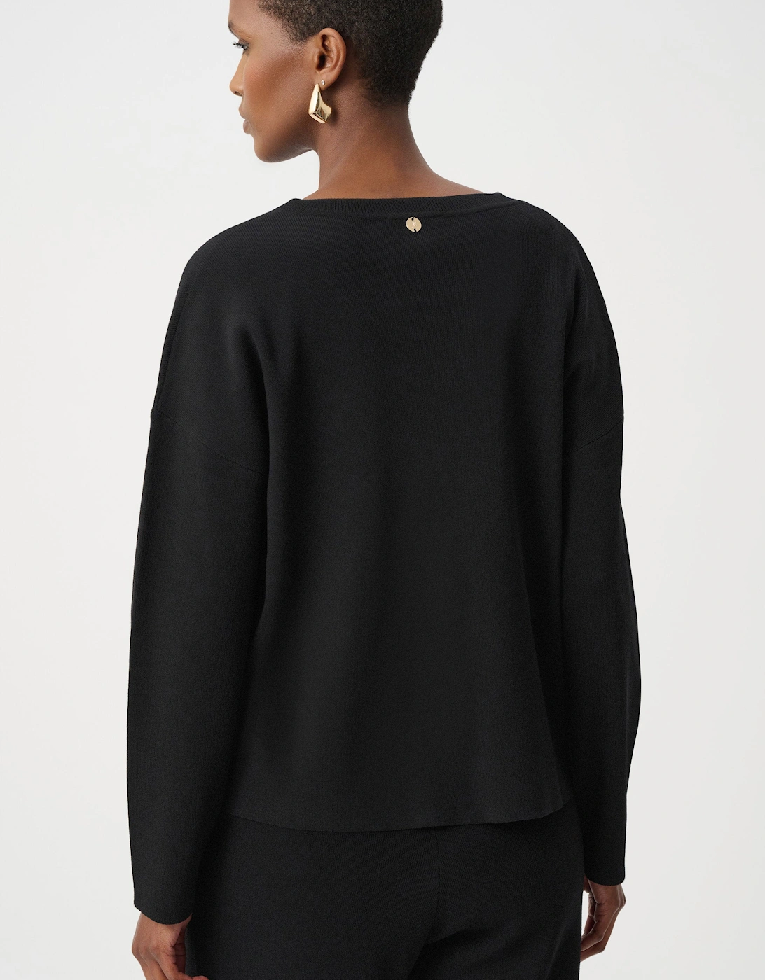 Asymmetric sweater with metal stud detail