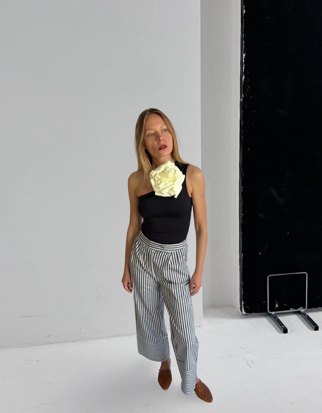 Black One Shoulder Top With White Flower Pin