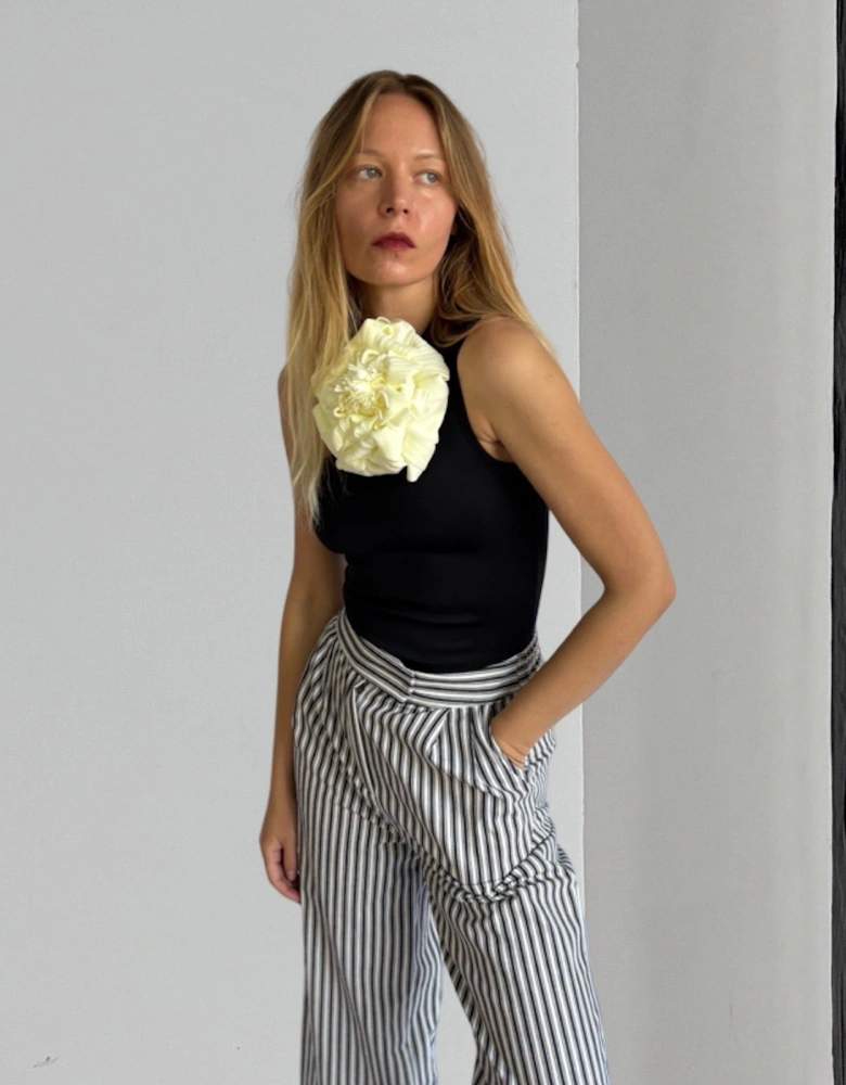 Black One Shoulder Top With White Flower Pin