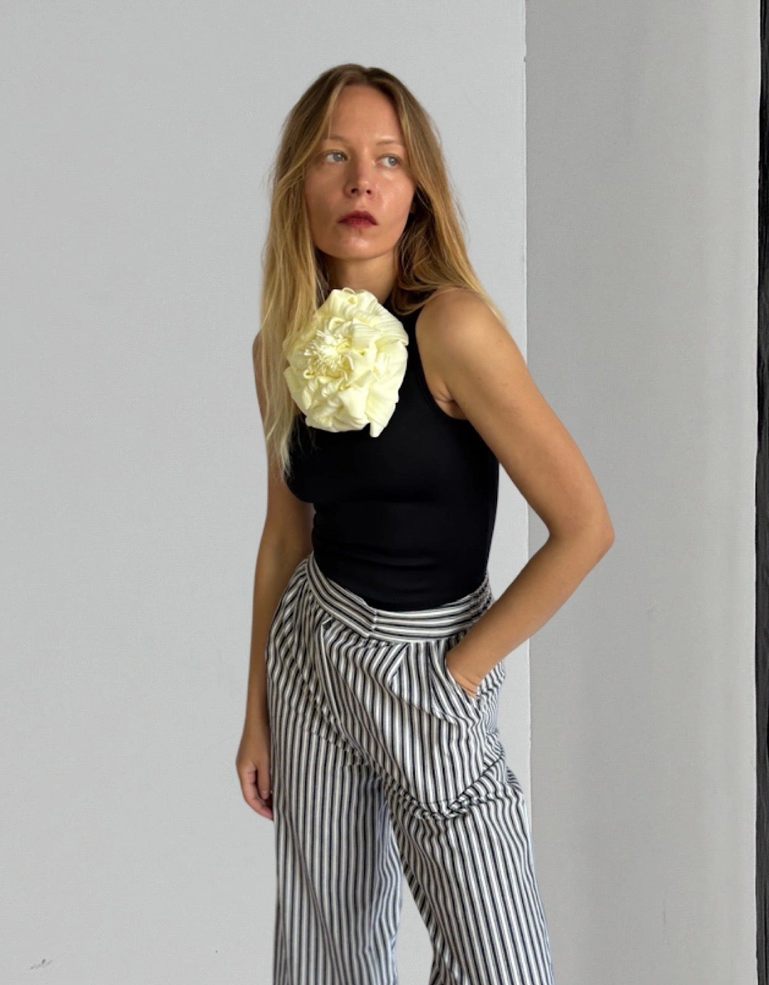 Black One Shoulder Top With White Flower Pin