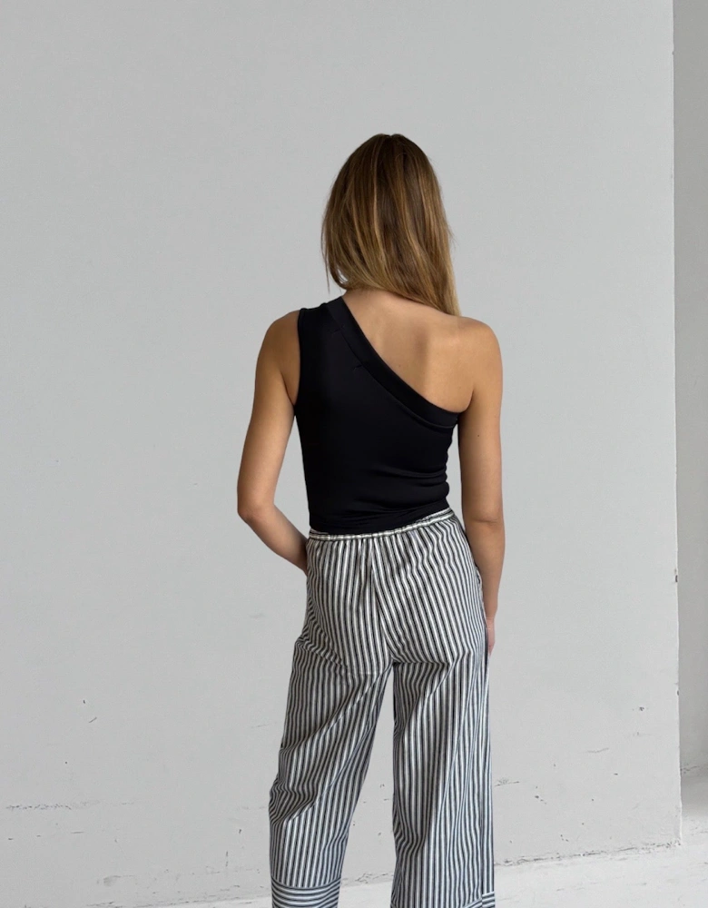 Black One Shoulder Top With White Flower Pin