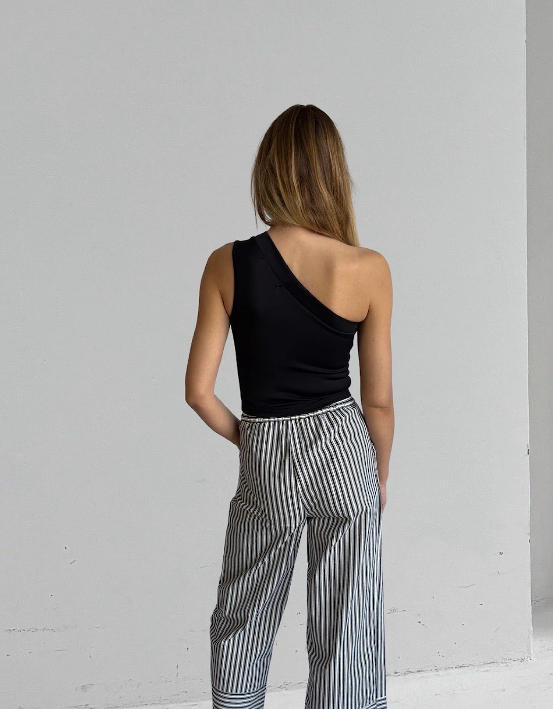 Black One Shoulder Top With White Flower Pin